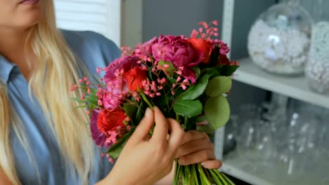 Professional-florist-making-beautiful-bouquet-at-flower-store