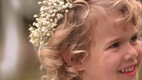 Portrait-of-little-flower-girl-smiling-on-wedding-day