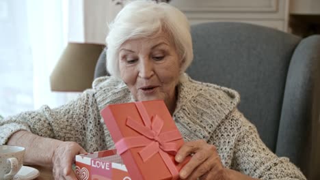 Senior-Lady-Opening-Gift-Box-at-Valentine-Day