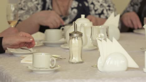 Senior-citizens-at-festive-dinner-eating-cake