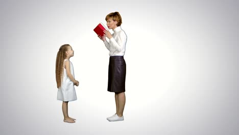 Happy-mother-and-daughter-giving-and-receiving-gift-box-on-white-background