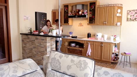 Two-friends-girls-prepare-breakfast-in-the-kitchen