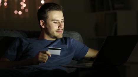 Happy-man-paying-online-with-credit-card-in-the-night