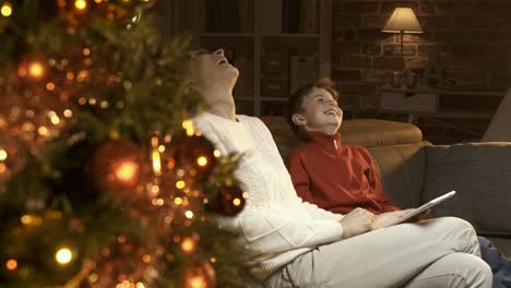 Boy-and-his-mother-using-a-digital-tablet-together-on-Christmas