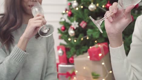 Group-of-cheerful-happy-young-Asian-woman-holding-and-drinking-glasses-of-champagne-in-christmas-party-at-home.-Lifestyle-women-celebrate-Christmas-and-New-year-concept.