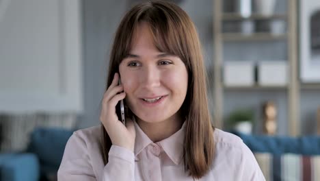 Young-Girl-Talking-on-Mobile-Phone,-Discussing