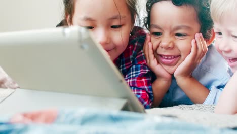 Multiethnic-Kids-Watching-Cartoon-on-Tablet-and-Laughing