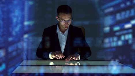 The-businessman-working-with-touchscreen-display-on-the-hologram-background