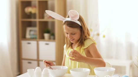 girl-coloring-easter-eggs-by-liquid-dye-at-home