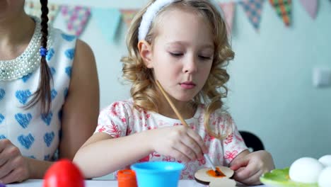 Cute-Girl-Coloring-Wooden-Easter-Bunny-with-Brush