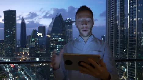 Caucasian-man-using-digital-tablet-for-internet-and-communications-with-cityscape-background