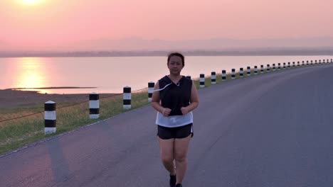 Overweight-Asian-women-jogging-in-the-street-in-the-early-morning-sunlight.-concept-of-losing-weight-with-exercise-for-health.-Slow-motion