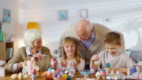 Family-Having-Fun-while-Painting-Eggs