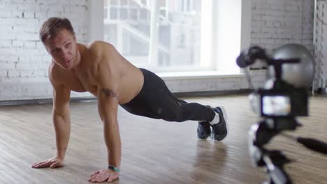 Shirtless-Male-Coach-Explaining-How-to-Do-Push-Ups-on-Camera