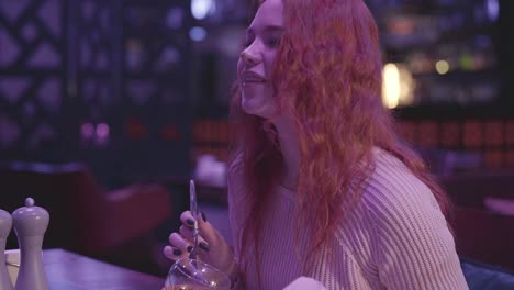 Two-cute-girlfriends-have-dinner-in-a-modern-restaurant-together.