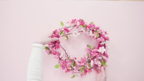 pink-silk-flower-wreath-on-a-pink-background.