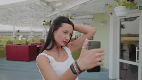 Beautiful-woman-making-selfie-on-the-veranda-of-the-restaurant