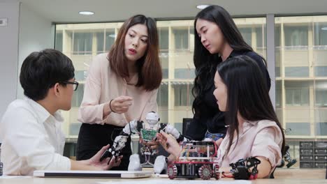 Group-of-electronics-engineer-collaborating-on-design-of-robot-in-lab.-Technology-and-innovation-concept.