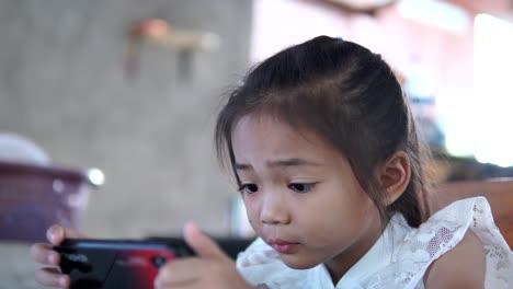 Asia-girl-playing-game-online-on-mobile-phone