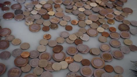 counting-coins,-counting-metal-money-in-a-grocery-store,