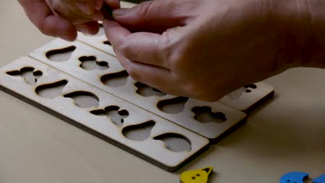 autistic-boy-arranges-objects-in-a-form_clouseup