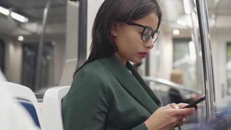 Woman-Using-Smartphone-in-Subway-Car