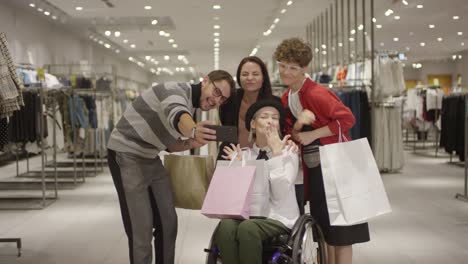 Diverse-Group-of-Friends-Taking-Selfie-in-Clothes-Store