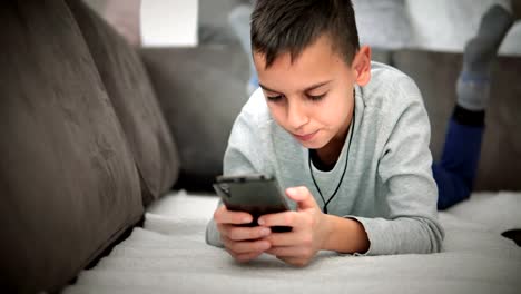 Cute-little-boy-watching-cartoons-on-mobile-phone