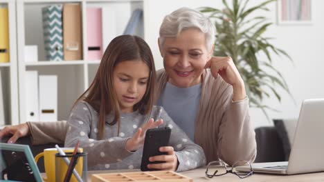 Grandmother-and-Granddaughter-Mastering-Mobile-Phone