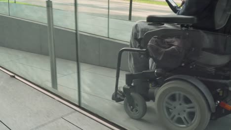 4k-resolution-follow-of-a-man-on-electric-wheelchair-using-a-ramp.-Accessibility-concept