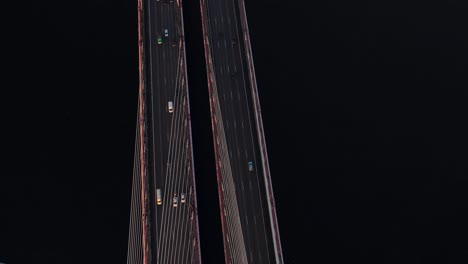 Aerial-or-top-view-from-drone-of-concrete-bridge-with-asphalt-road-or-highway-over-big-river-with-city-car-traffic,-urban-transportation,-toned