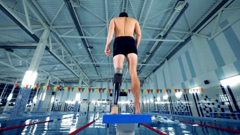 Swimming-pool-and-a-man-with-a-robotic-leg-warming-up