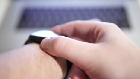 Close-up-of-men's-hands-uses-smartwatch-with-touchscreen,-a-smart-device-on-the-wrist