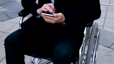 Male-disabled-working-with-mobile-phone