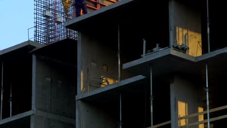 Constructors-building-multi-storey-office-building-in-city,-industrial-safety