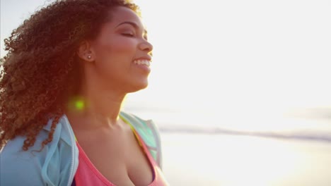 African-American-female-enjoying-ocean-sunrise-in-summer