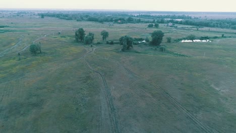 Aerial-View-of-road-between-green-fields.