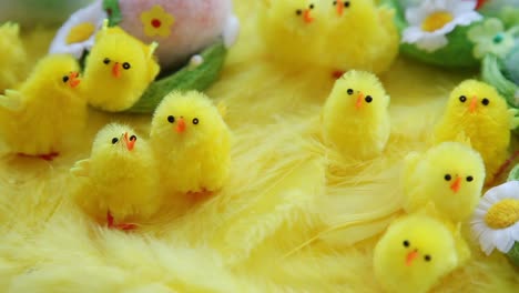 Baby-yellow-Easter-toys-chicks-and-eggs-on-a-background-of-feathers.-Festive-video-greeting-card