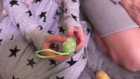 Small-girl-hands-with-decorative-Easter-eggs