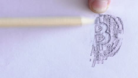 Young-male-professional-is-drawing-bitcoin-image-on-white-paper-using-pencil,-on-table-in-trader-company,-person-depicts-symbol-of-peering-payment-system-on-sheet-on-desk-in-room-with-daylight