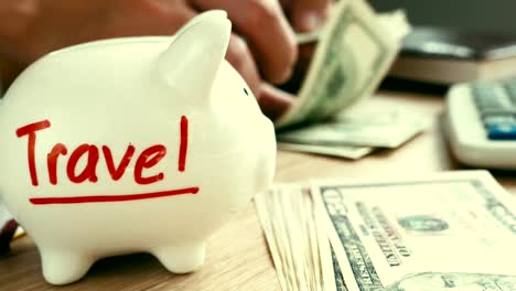 Travel-on-a-piggy-bank-and-hands-holding-money.-Savings-for-vacation.-Holidays-cost.