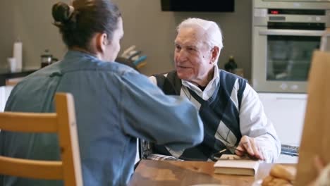 Young-Man-Helping-Elderly-Man-with-Household-Bills