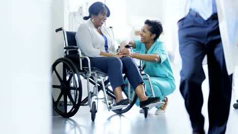 Multi-ethnic-team-with-senior-patient-in-wheelchair