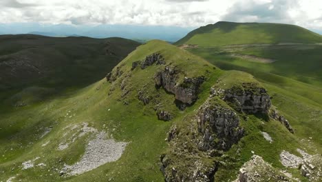 Flying-over-a-large-rock-formation-among-the-green-fields.-Russia.-North-Caucasus-Video-from-the-drone