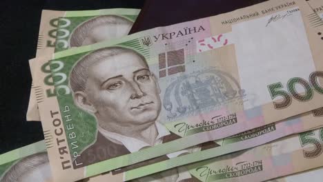 Money-of-Ukraine,-500-hryvnia-fall-on-the-table