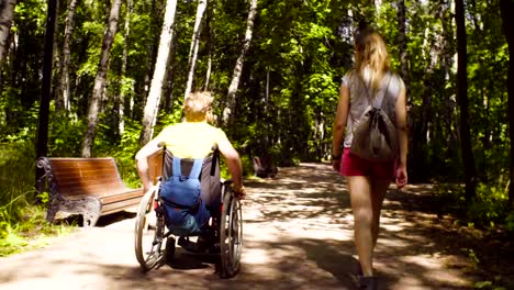 Young-disable-man-with-his-wife-on-a-walk-in-the-park