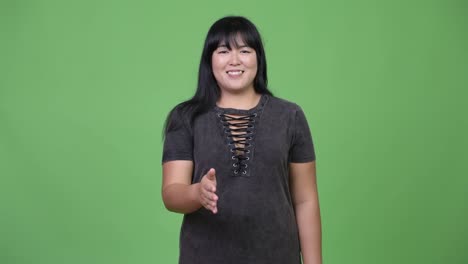 Happy-overweight-Asian-woman-giving-handshake