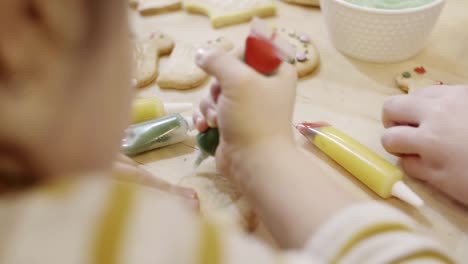 Human-hand-decorating-easter-cookie