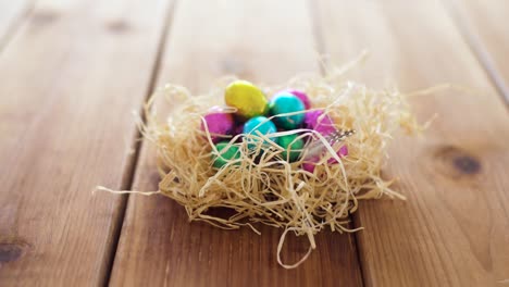 chocolate-easter-eggs-in-straw-nest-on-table