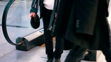 Anonymous-People-Walking-on-the-Escalator-Lift-in-Shopping-Mall